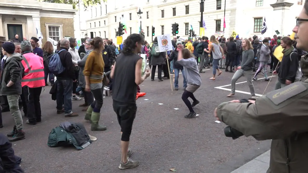 Protesters dance during the Extinction Rebellion protests in London UK