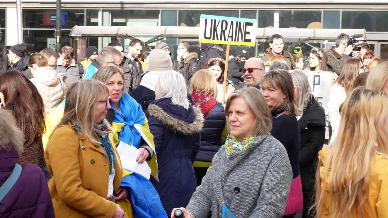 Crowd of people at Ukraine anti war protest activists on Manchester city street