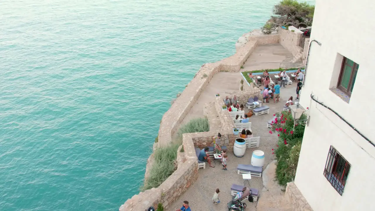 People Gathered At The Bar Of The Peniscola Fortress During Summer In Peniscola Castellon Province Spain