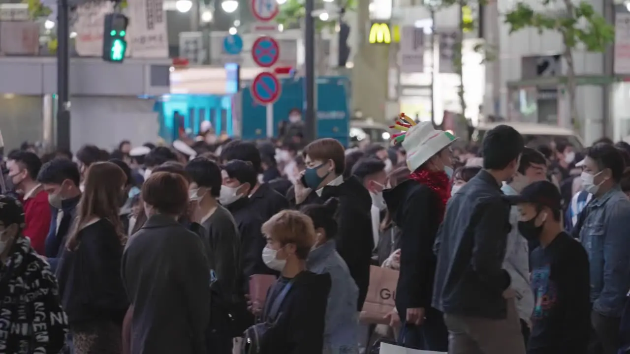 Crowd Of People At Shibuya Crossing In Tokyo Japan On Halloween Night medium shot slow motion