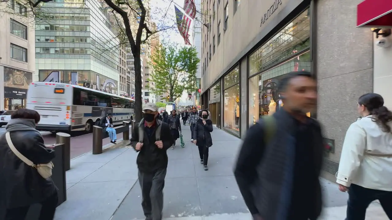 First-person view of people walking in 5th Avenue busy street of Manhattan financial district in New York City USA