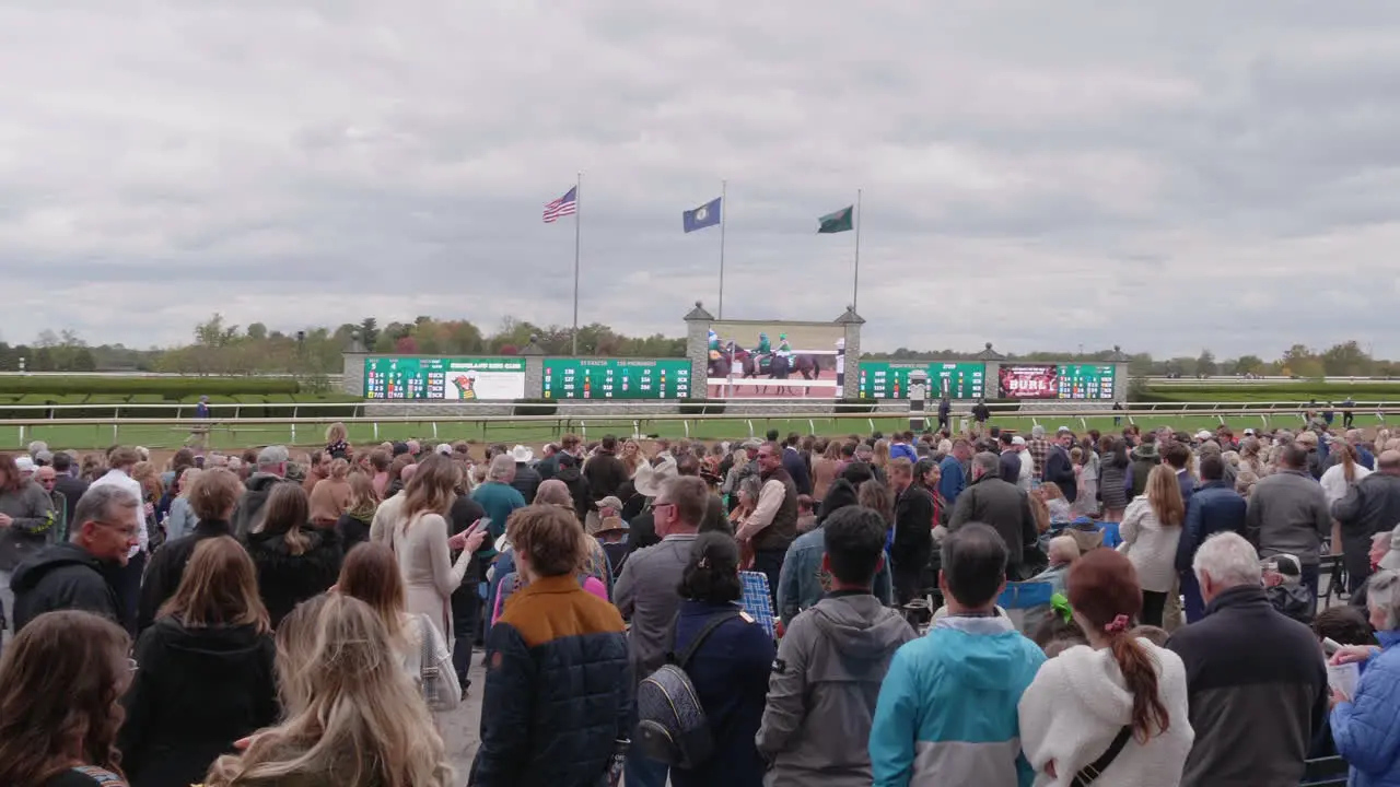 Panning shot of a crowd of people at Keenland race track horse race