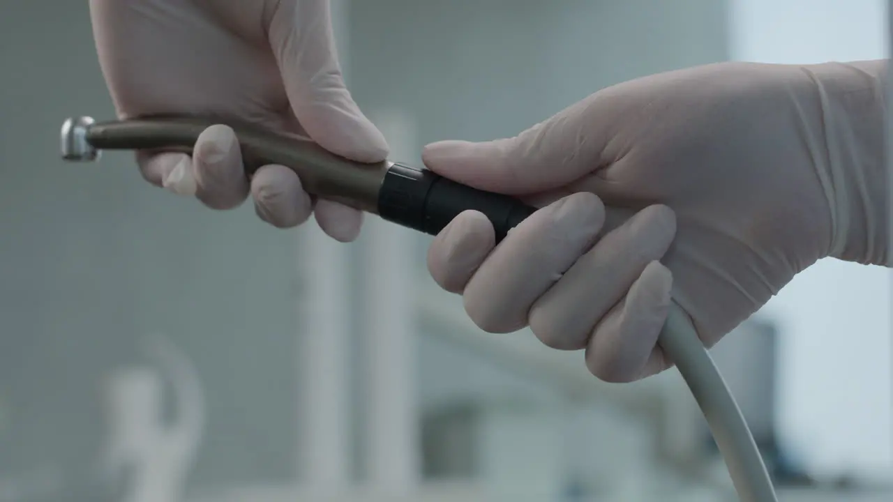 Close up on nurse hands assembling dental tool