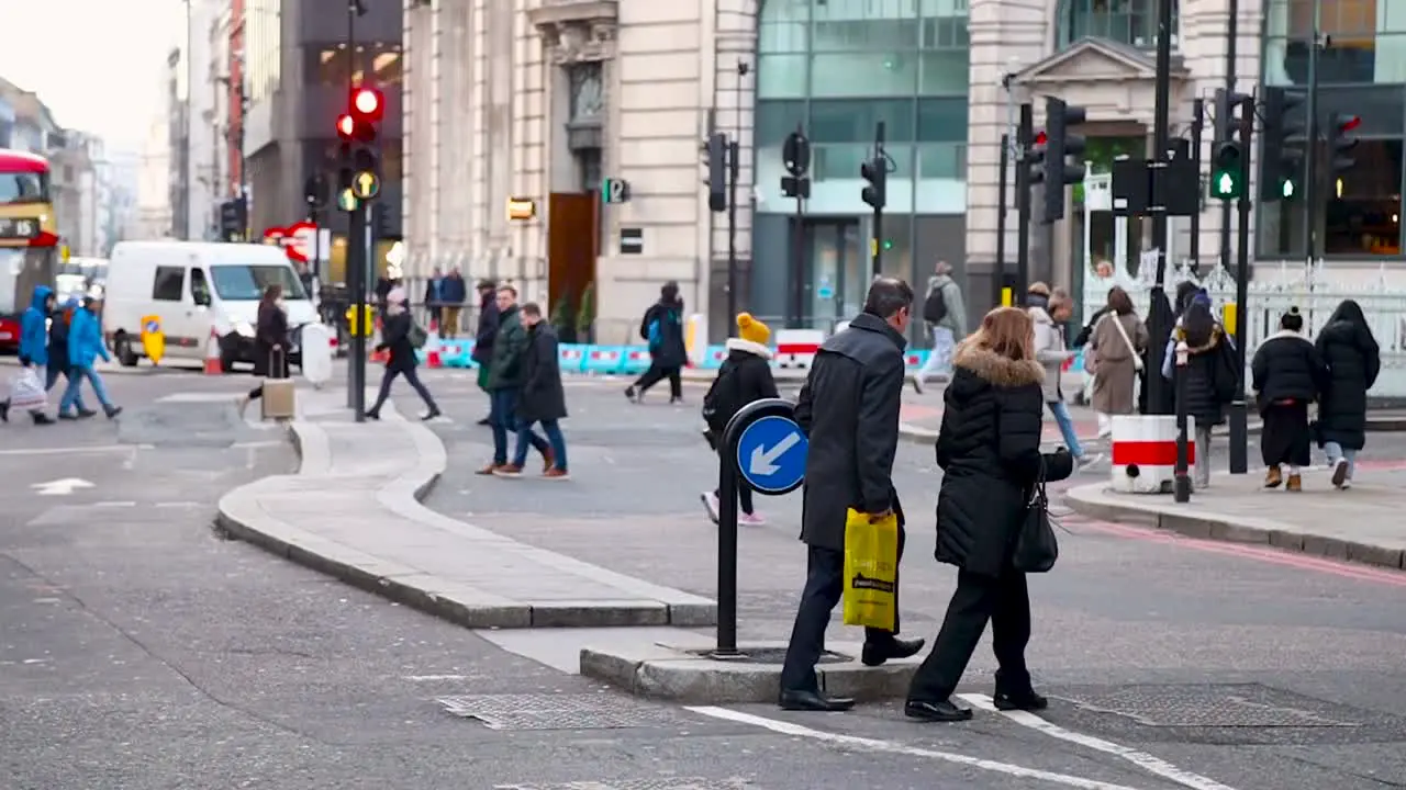 People crossing Eastcheap Street near Monument in London slow motion