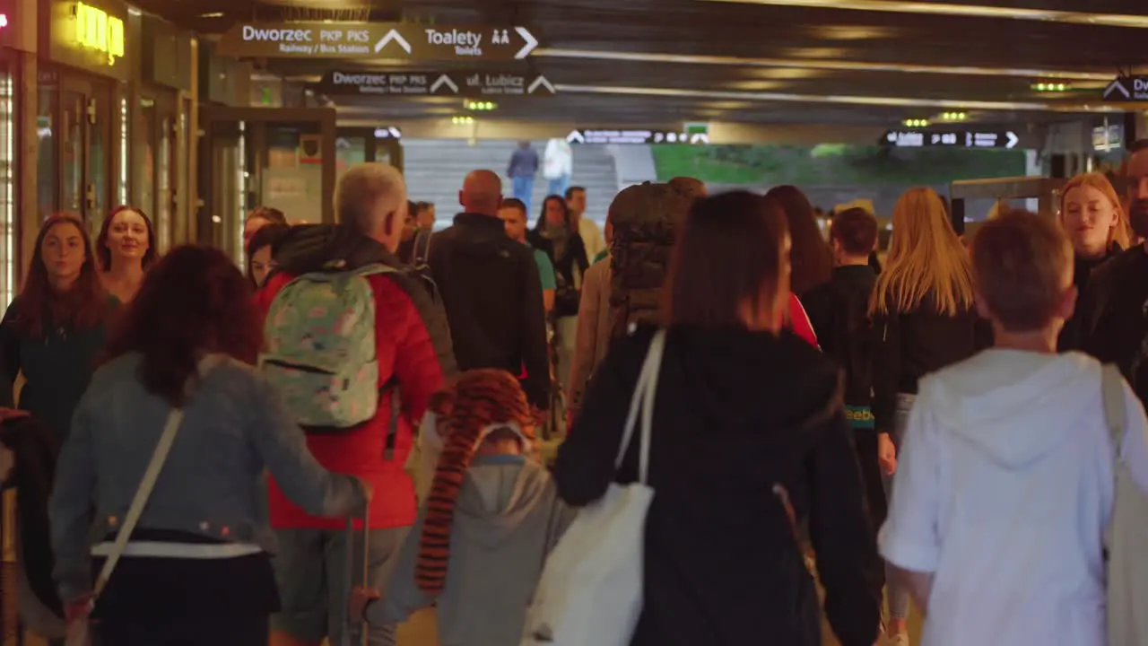 Video of a crowd of people strolling through underground shopping center in Kraków Poland