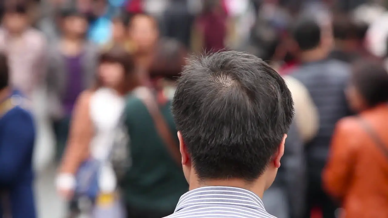 Huge crowds walk on the streets of modern day China 3