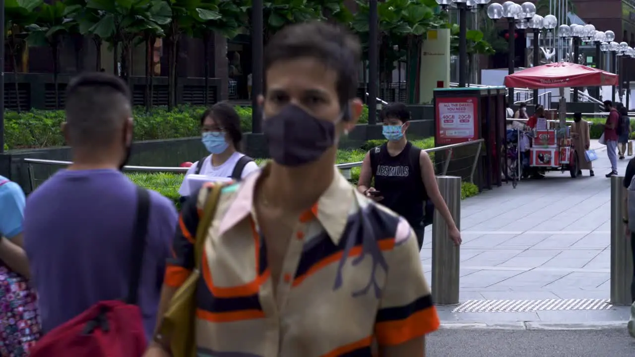 People wearing face mask at crowded pedestrian cross at Orchard Road