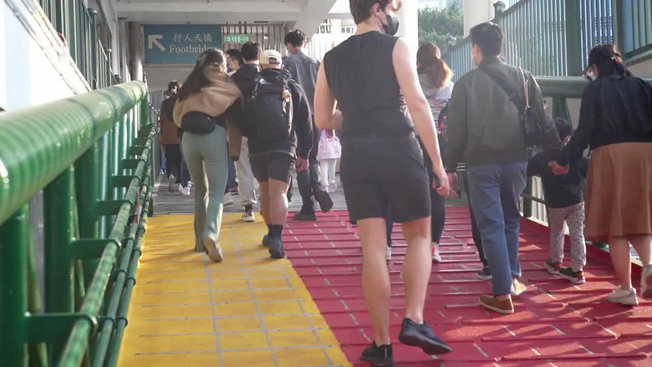 Asian people walking up ramp towards ferry Central ferry dock Hong kong