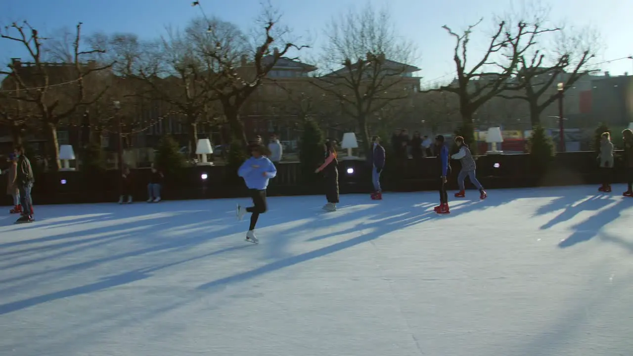 View of a large crowd of the people doing Ice skating near the Flevopark on a frozen lake in Amsterdam during winter season Christmas in Netherlands