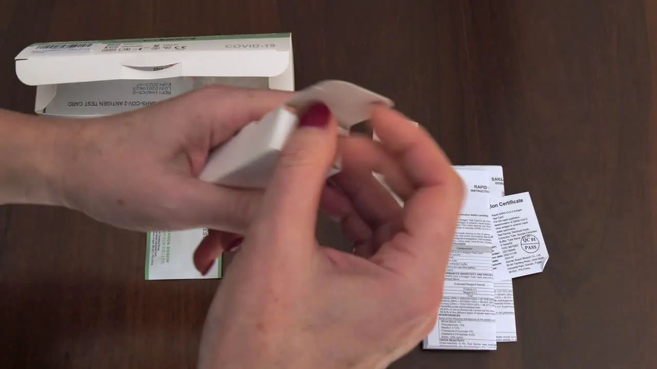 Hands woman close up opening a self rapid antigen test kit for covid sars infection pandemic