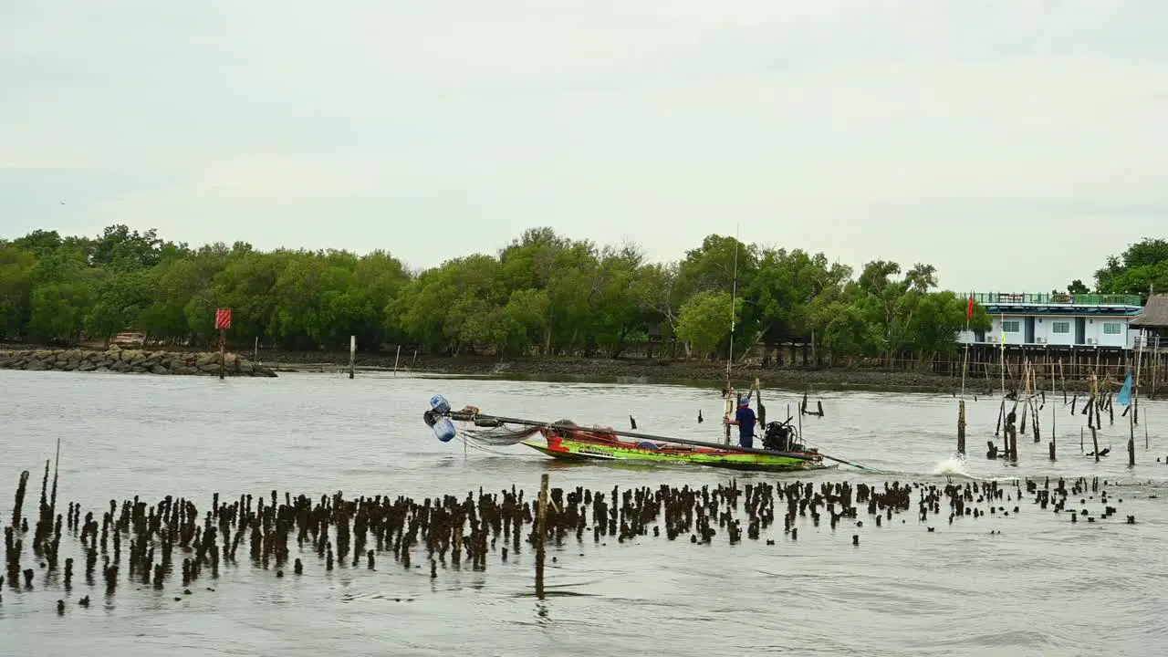 Fishing Boat with trolling implements followed by another boat