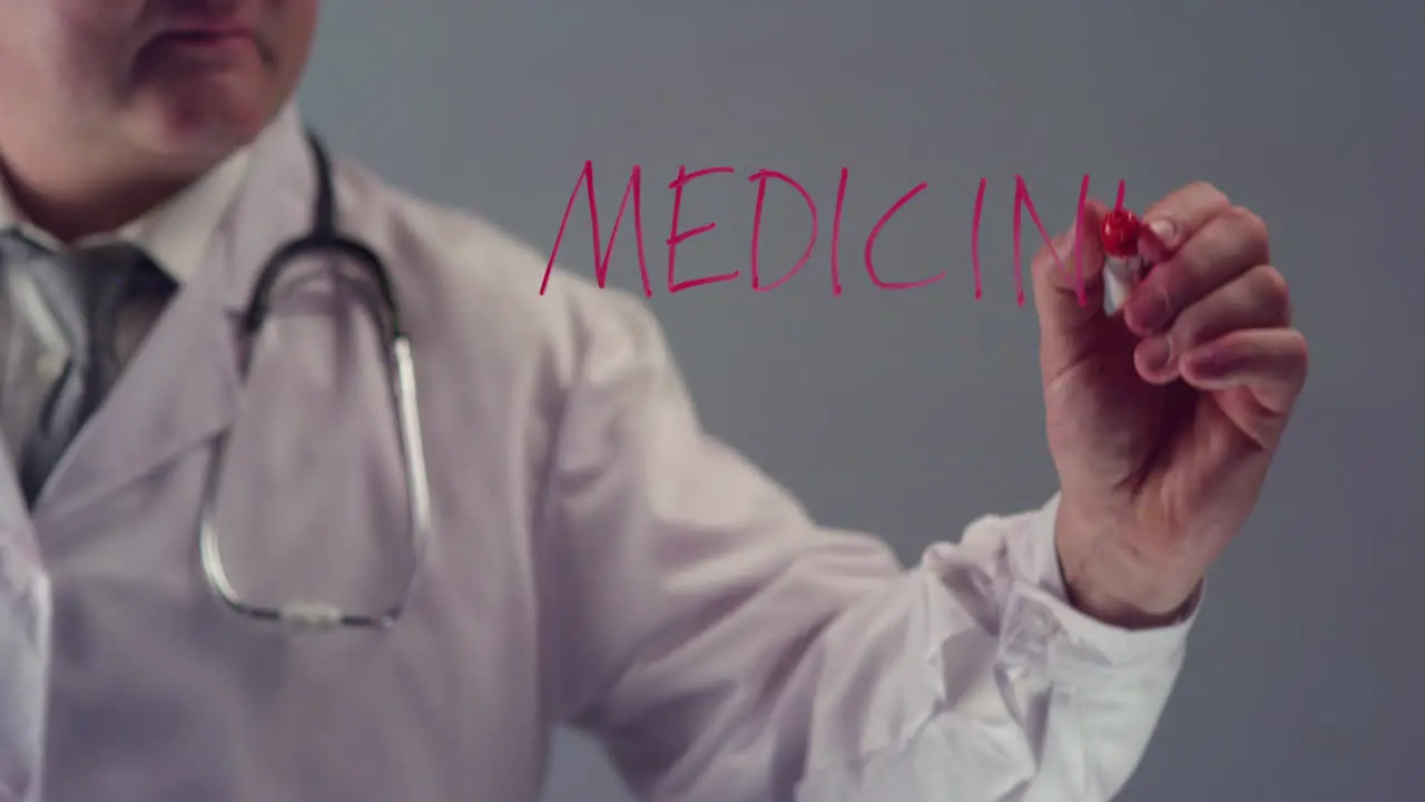 Doctor Writing the Term Medicine