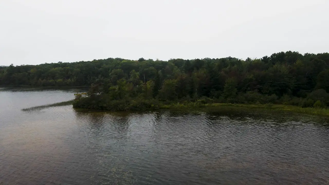 Still take as breeze lightly caresses the trees and water on Little Black Lake before a storm