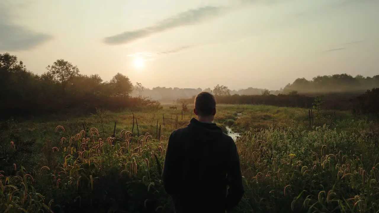 Male looking at city deer during morning walk