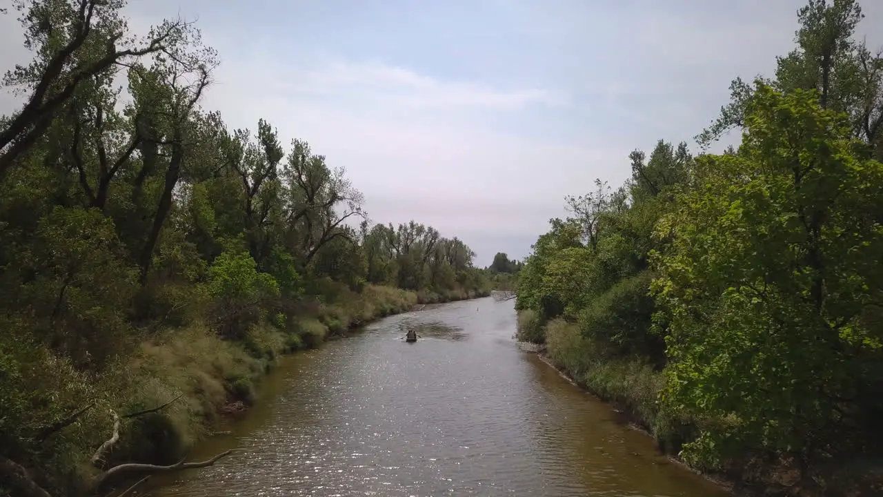 People Kayaking In Peaceful Calm Water River Exploring Wild Nature