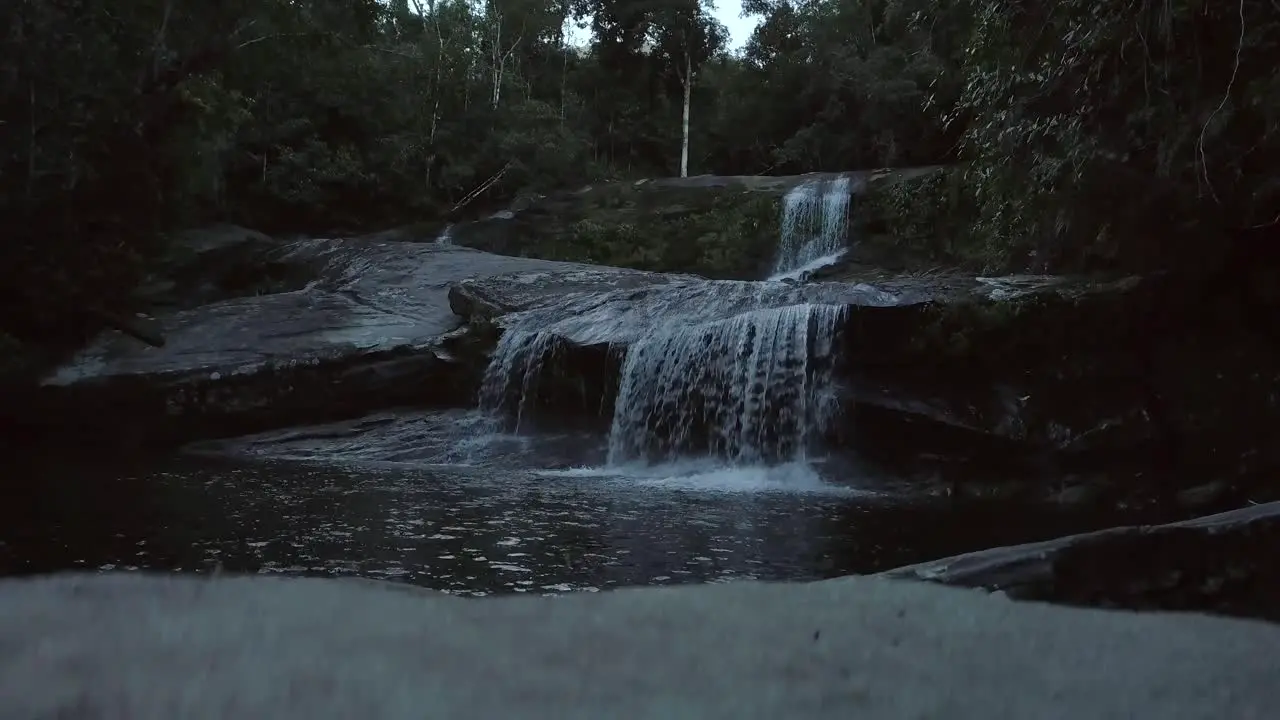 Slow lift in front of waterfall in Brazilian Amazon rainforest towards dusk