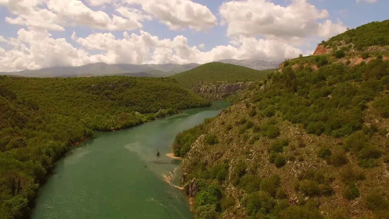 Drone over river green nature and sky full of clouds