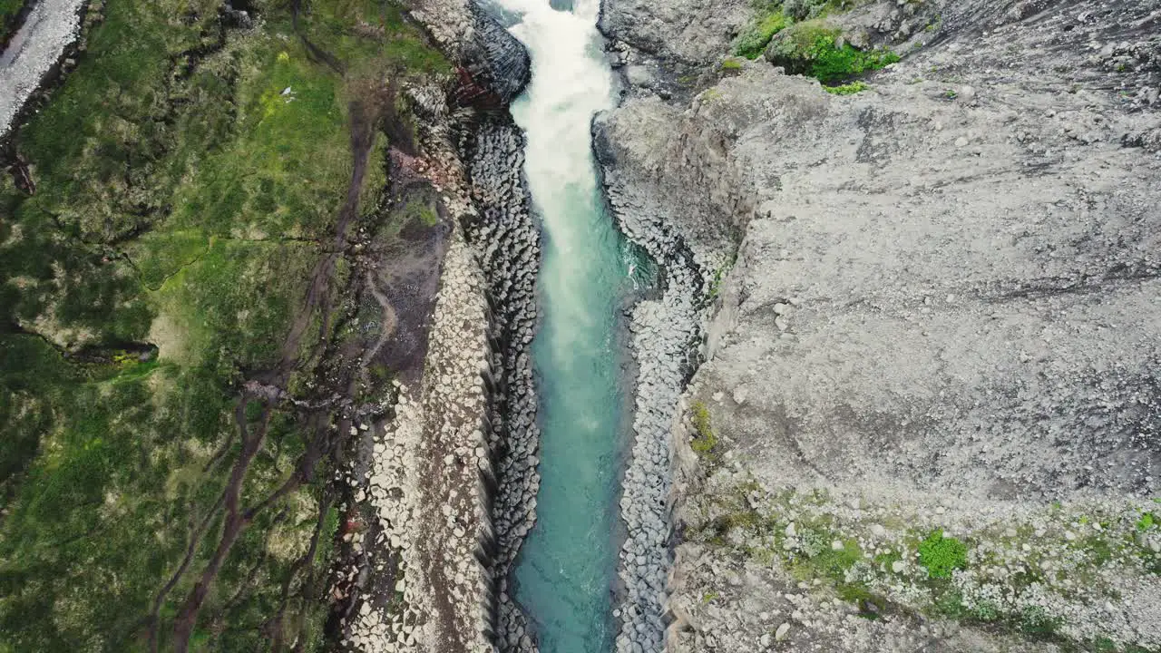 Drone flying downwards with the camera tilting up in the Studlagil canyon in Iceland 4k