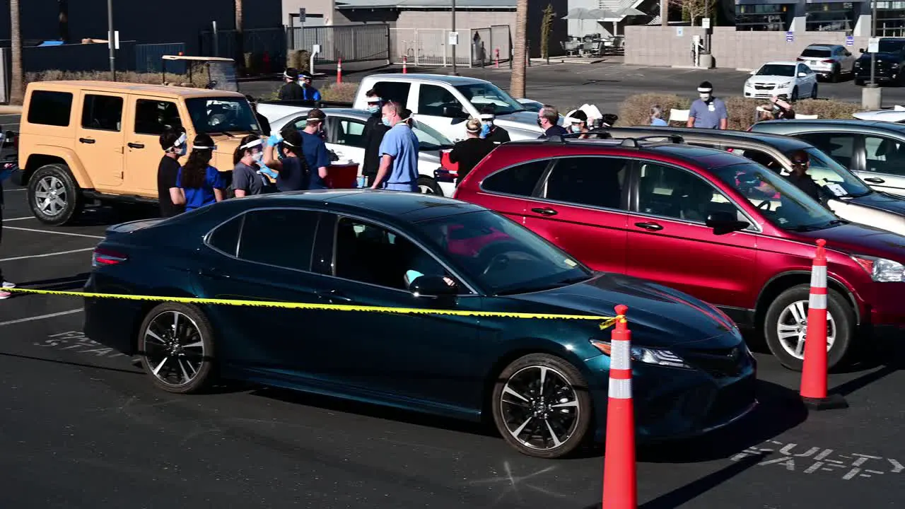 People in cars wait in observation after receiving the Covid-19 vaccine