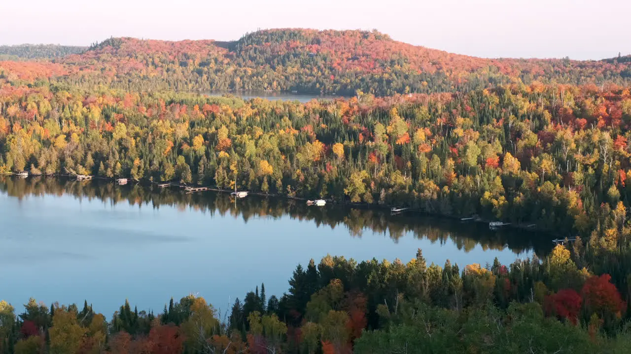 Slow Pan Of Scenic Lake Cabins With Fall Colors