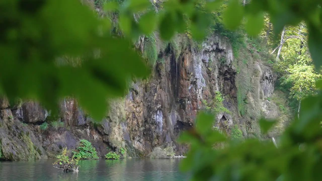 Beautiful view of a cliff and a lake seen through tree branches