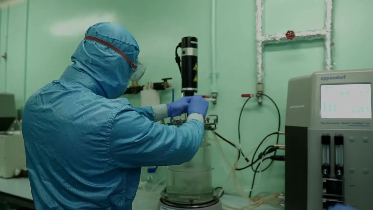 Medical Research Lab Scientists Using Microbial Fermenter In Hospital