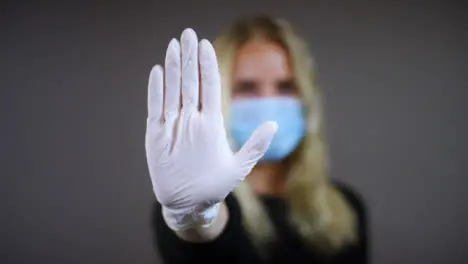 Woman Uses Stop Gesture with Glove