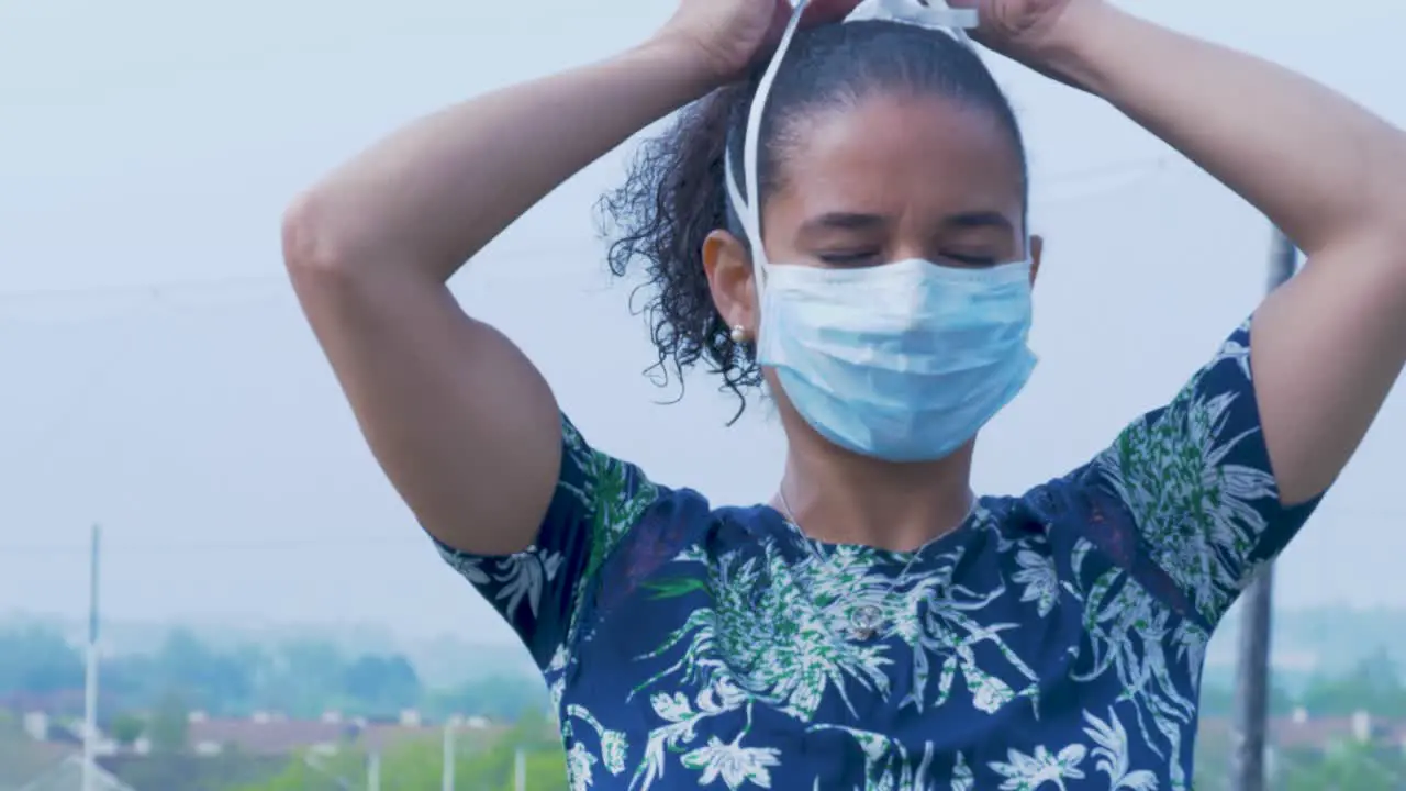 Woman puts on a Surgical Medical Face Mask