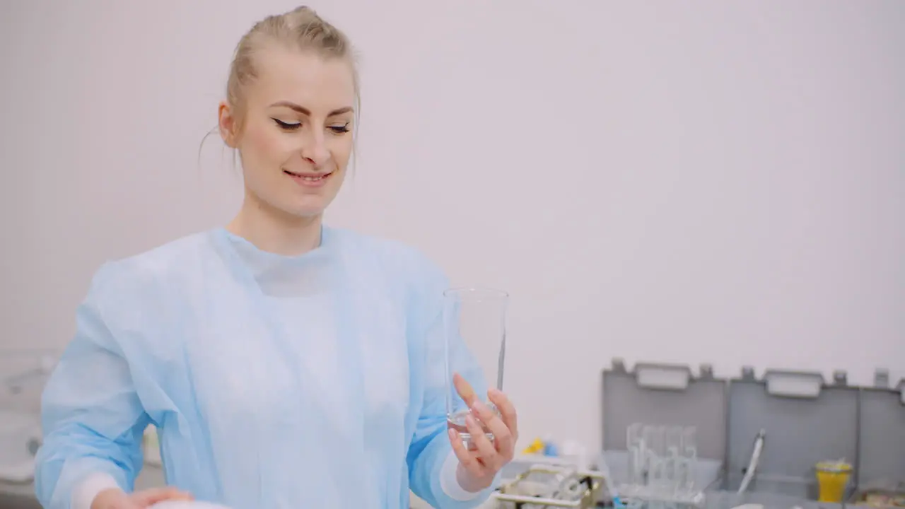 Extreme Close Up Of Female Doctor Drinking Glass Of Water