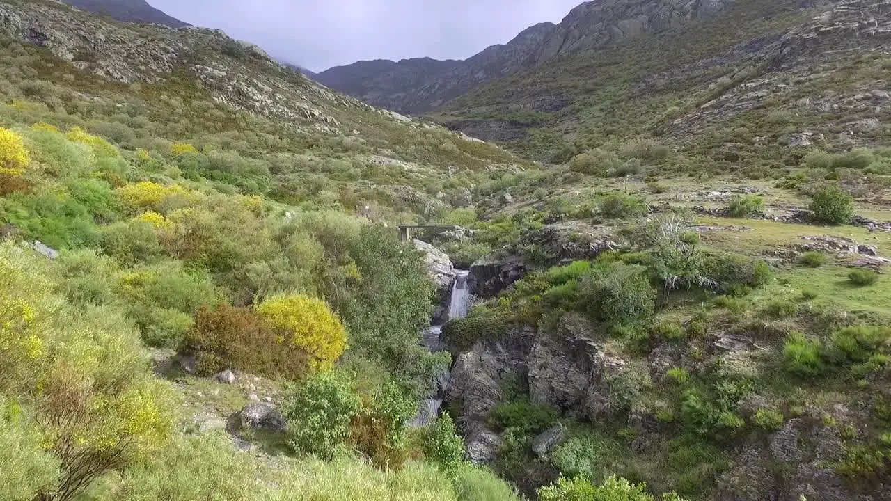 Little stream with waterfall in a valley in Palencia aerial shot