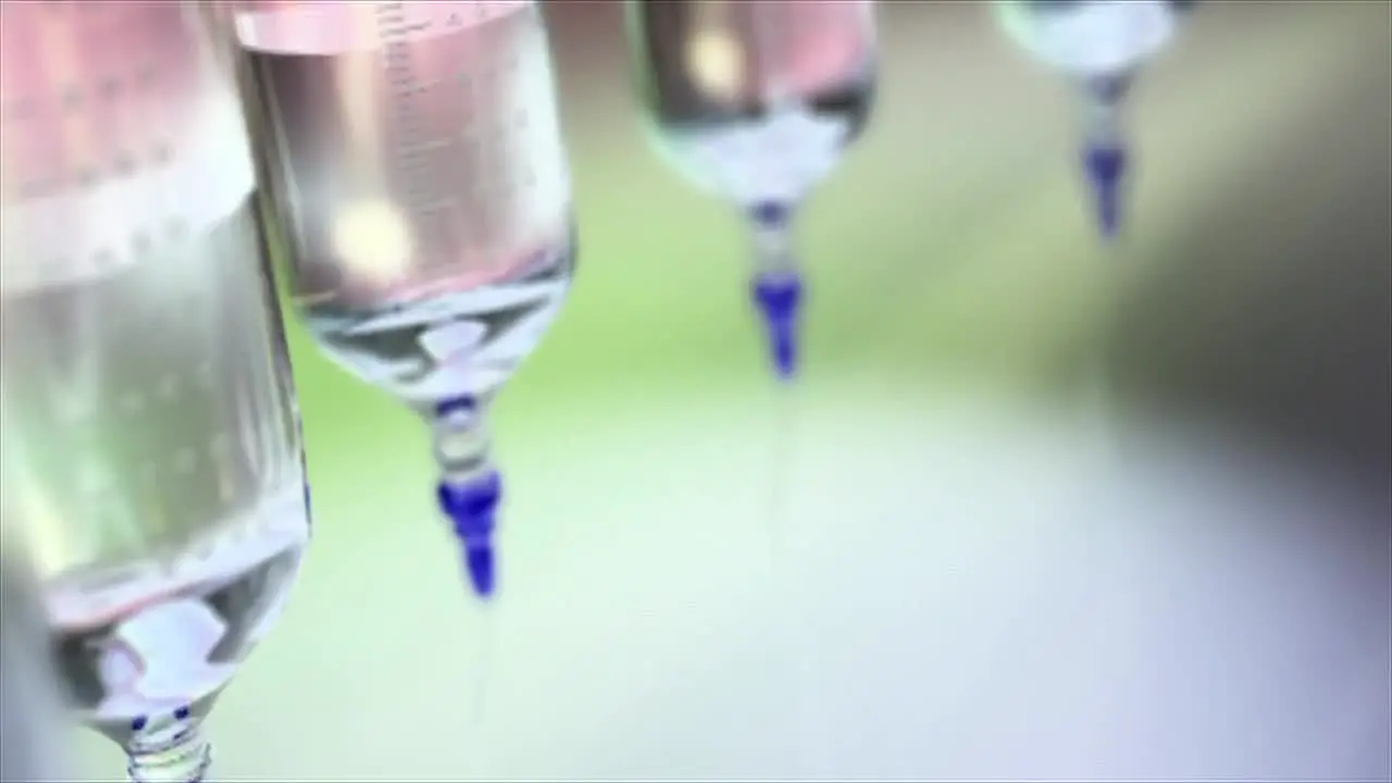 Close up of rotating medical grade syringes they are hanging upside down and moving in circle shape