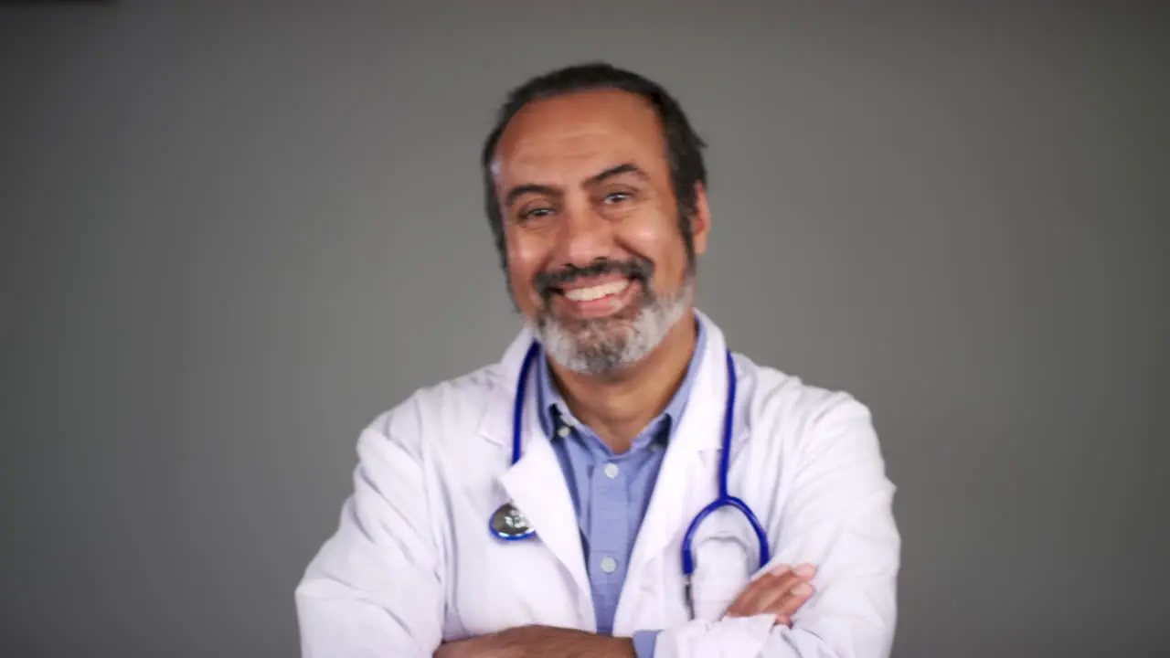 Pull Focus of Middle Aged Doctor Folding Arms and Smiling