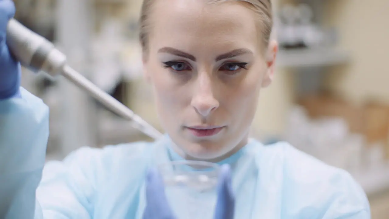 Scientist Using Pipette During Experiment At Laboratory 1