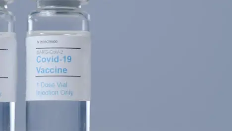 Sliding Extreme Close Up Shot of Covid Vaccine Vial with Right Copy Space