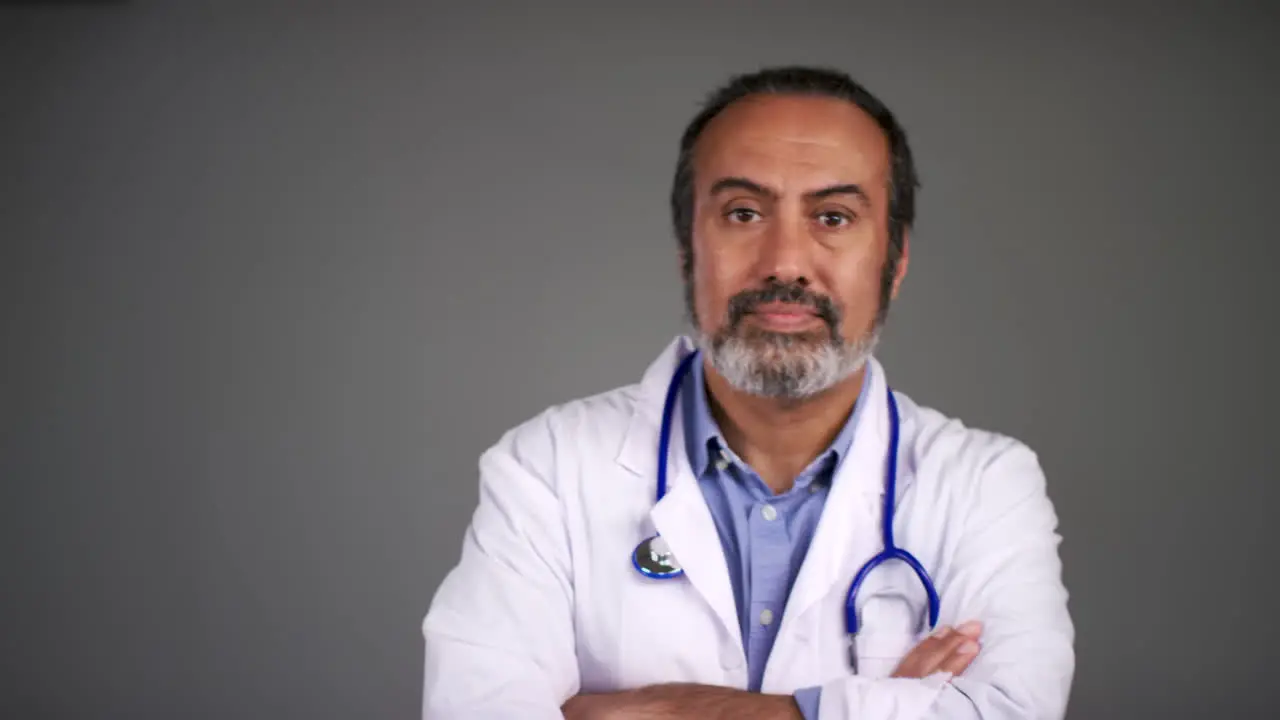 Pull Focus of Middle Aged Doctor Fold Arms and Looks Serious