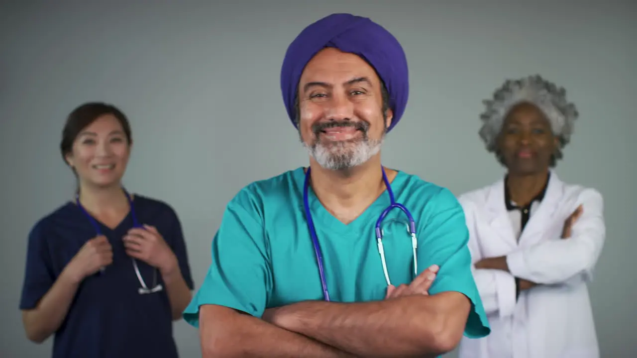 Pull Focus of Three Happy Middle Aged Doctors Smiling Portrait