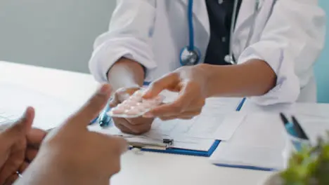 Doctor Handing Medication To Patient