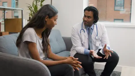 Doctor Explaining Difficult News to Young Woman