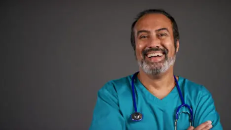 Middle Aged Friendly Doctor Smiling and Folding Arms Portrait