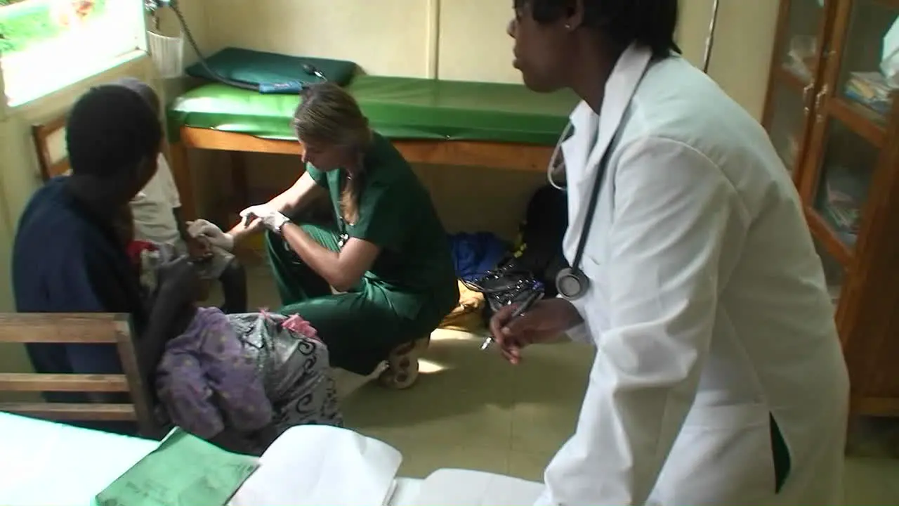 Sick children are getting a checkup by two doctors at a clinic