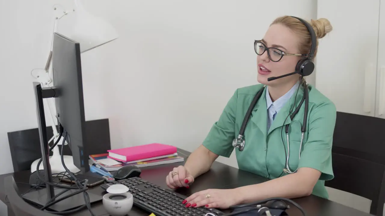 Beautiful female doctor having online conversation with a patient Sitting in front of computer