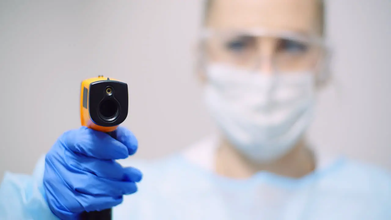 Doctor Measuring Patient Temperature At Health Care Clinic 3