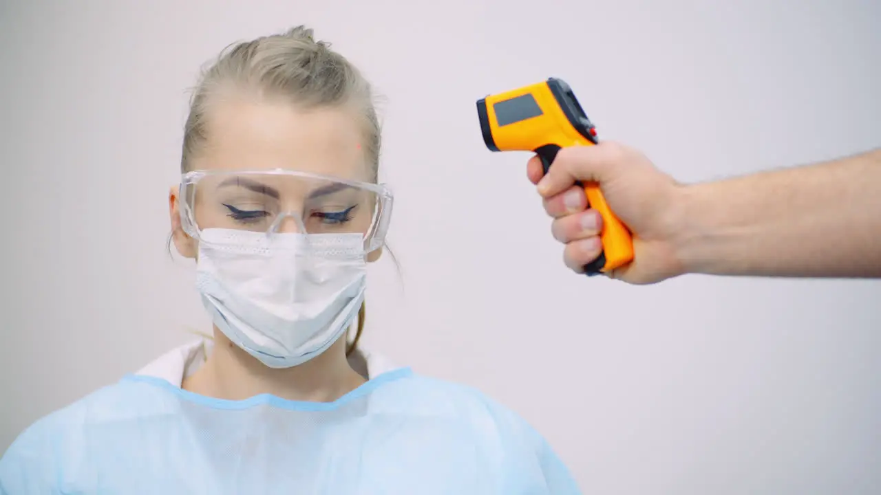 Doctor Measuring Patient Temperature At Health Care Clinic 8