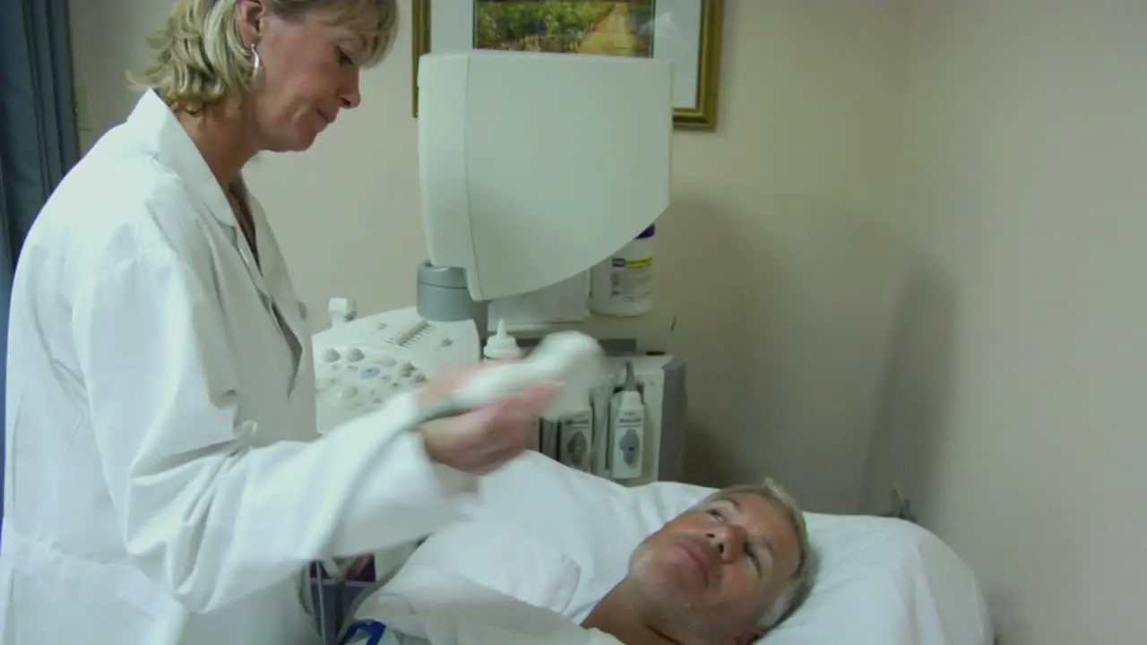 A female technician uses an ultrasound machine on a patient