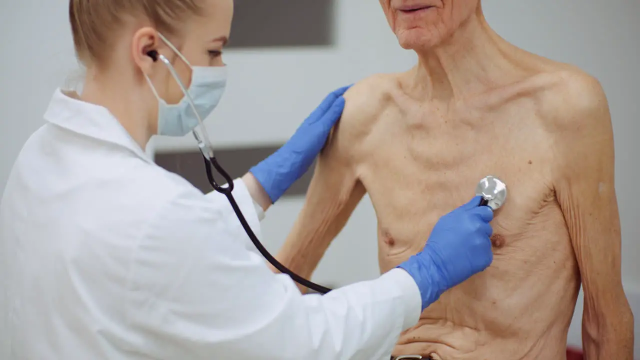 Female Doctor Examine Elderly Man With Stethoscope 1