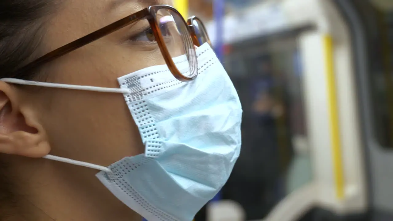 Passenger wearing a face mask on underground train