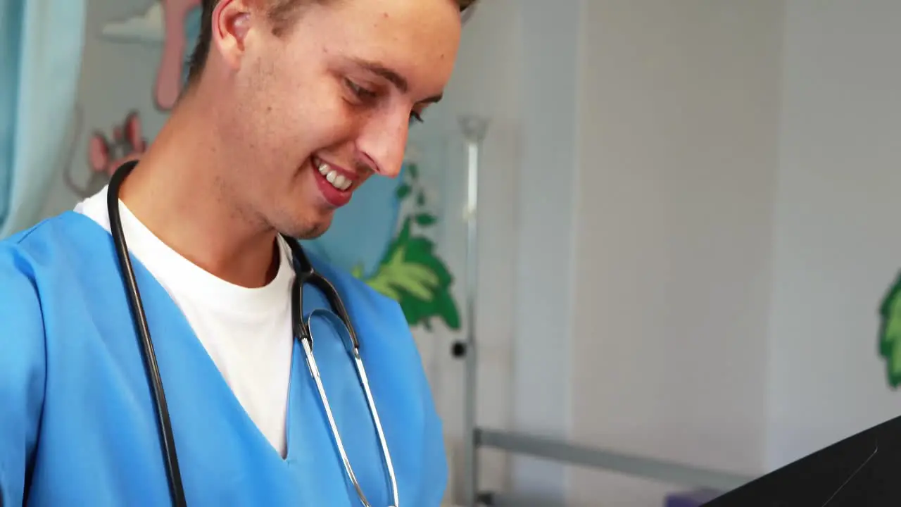 Smiling doctor checking medical report in hospital