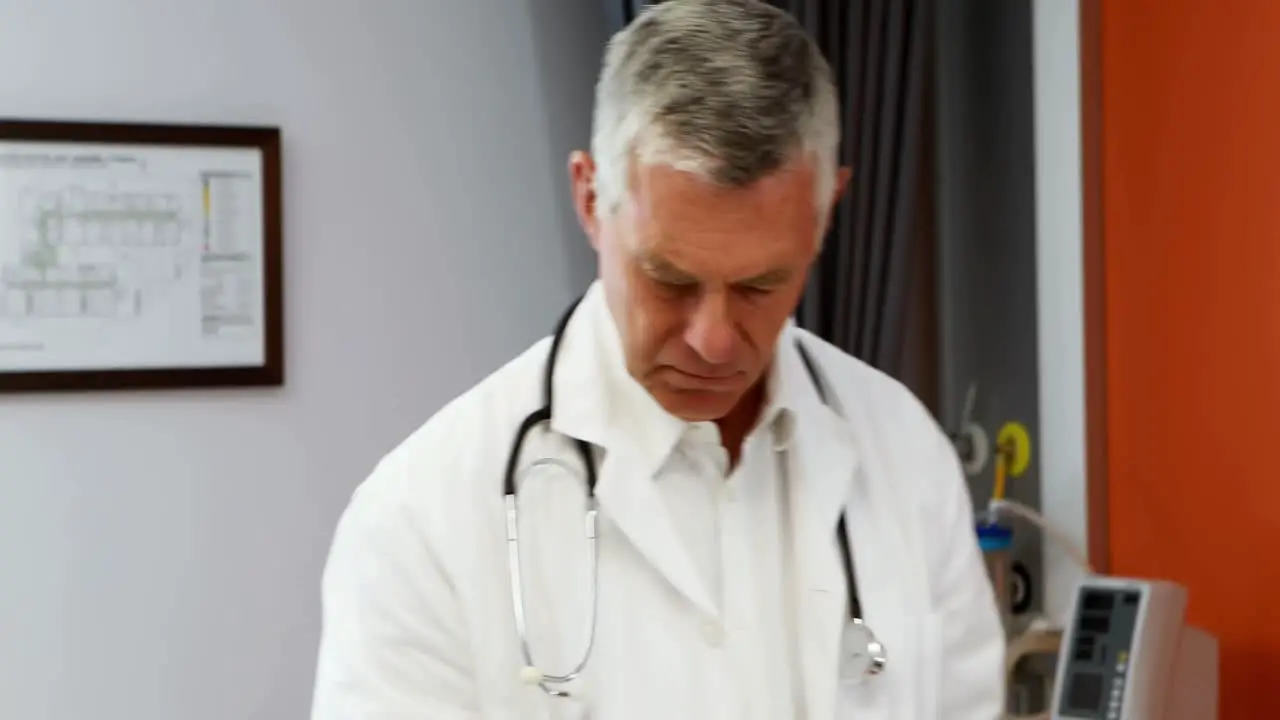 Male doctor using digital tablet while measuring height of girl