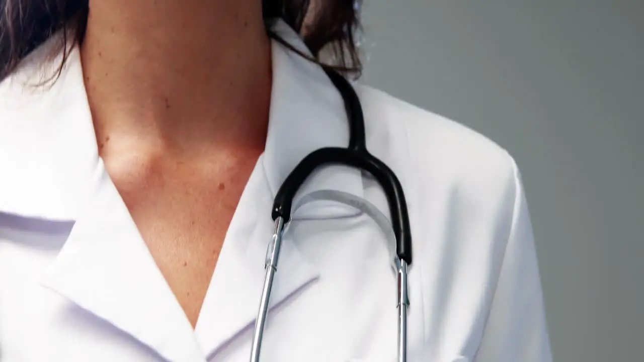 Portrait of female doctor checking time