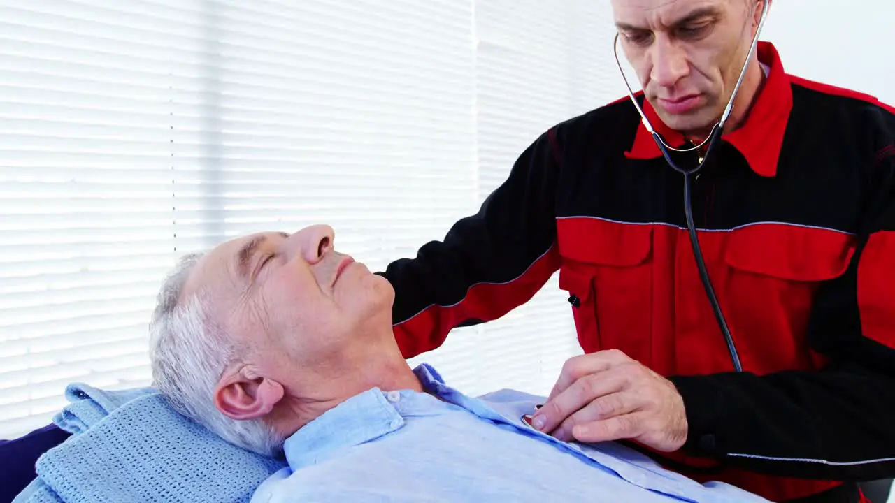 Male paramedic examining a patient